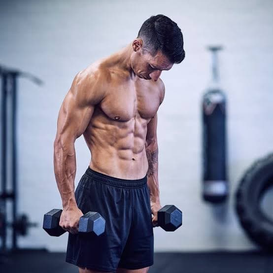 Athlete holding dumbbells in a gym